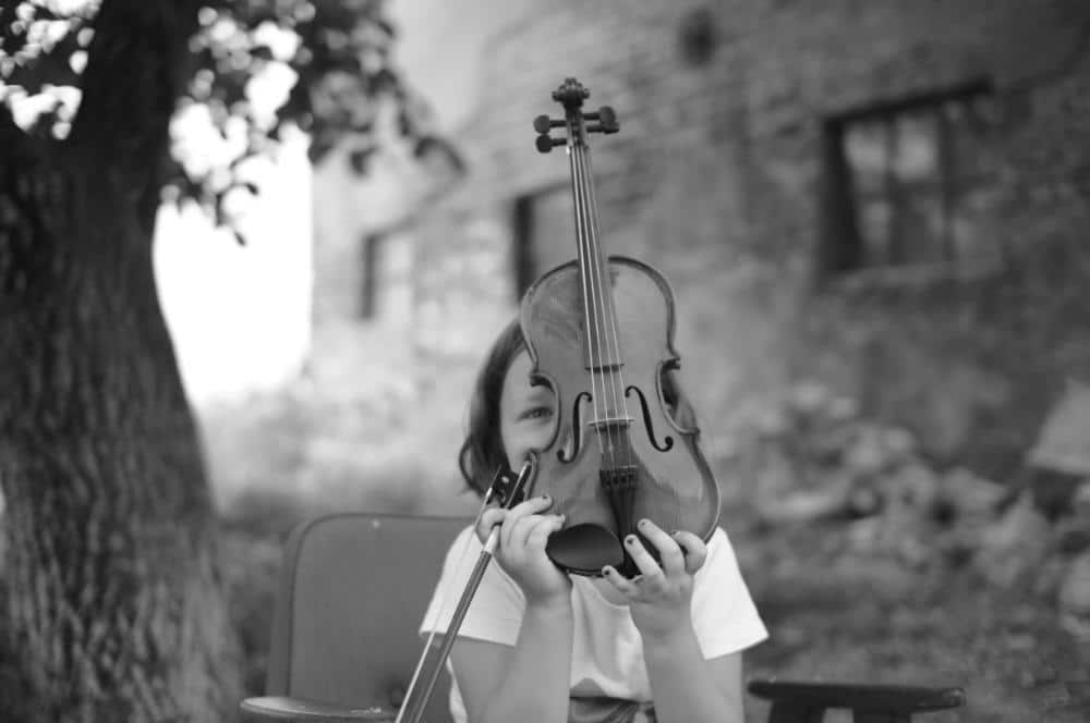 a girl holds a violin