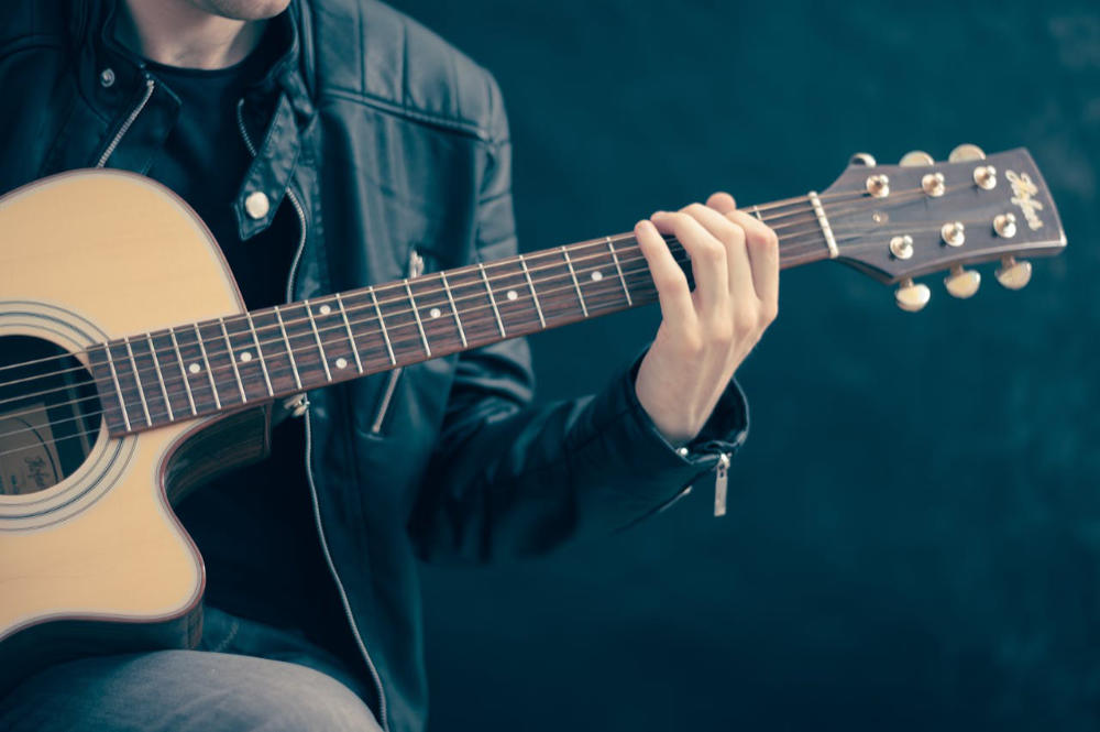 man plays guitar